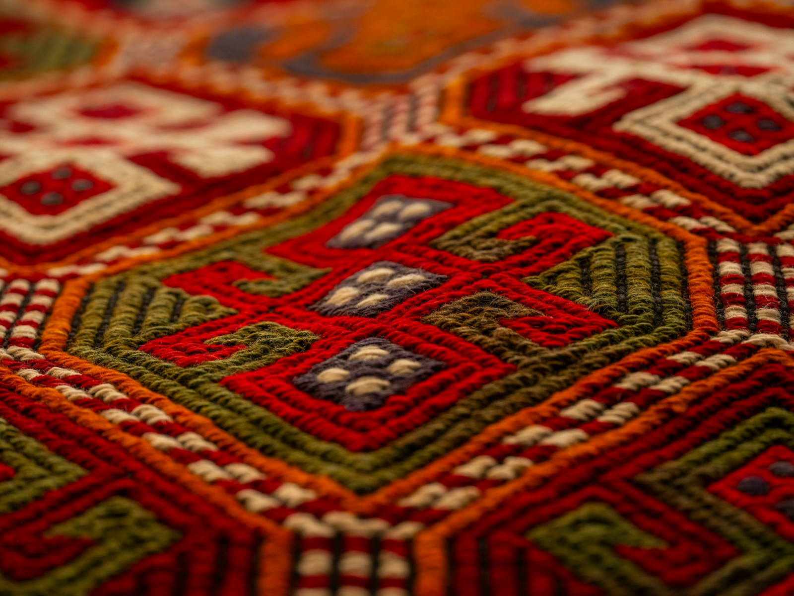 A close up of a red and green rug