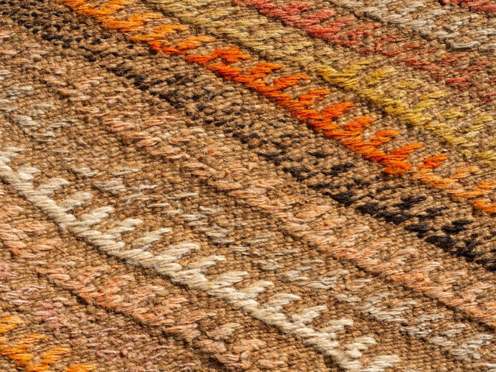 A close up of a multi colored rug